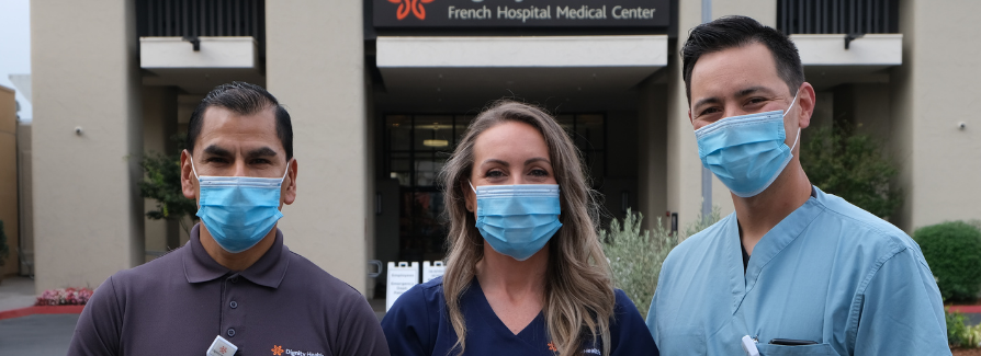 Food service worker, nurse and physician standing in front of French Hospital Food service worker, nurse and physician standing in front of French Hospital