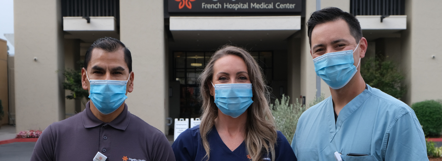 Food service worker, nurse and physician standing in front of French Hospital