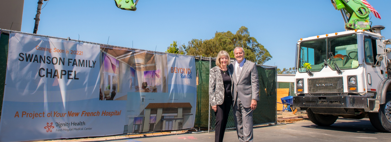 Donors Bill and Cheryl Swanson stand in front of the construction site for the Swanson Family Chapel