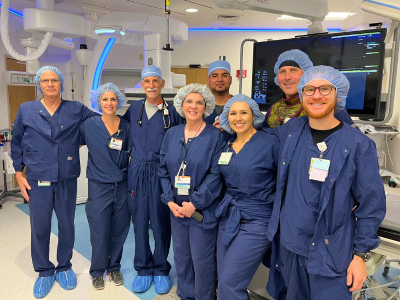 Eight members of French Hospital's cardiac team standing in the new cath lab in scrubs