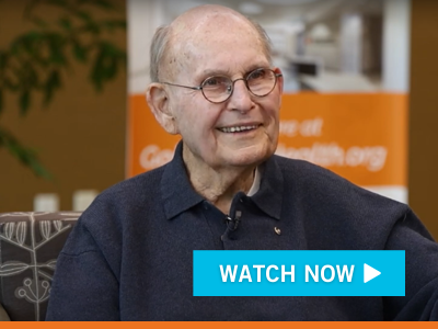 Video Still Image of Gil Stork. Play Button overlaid.