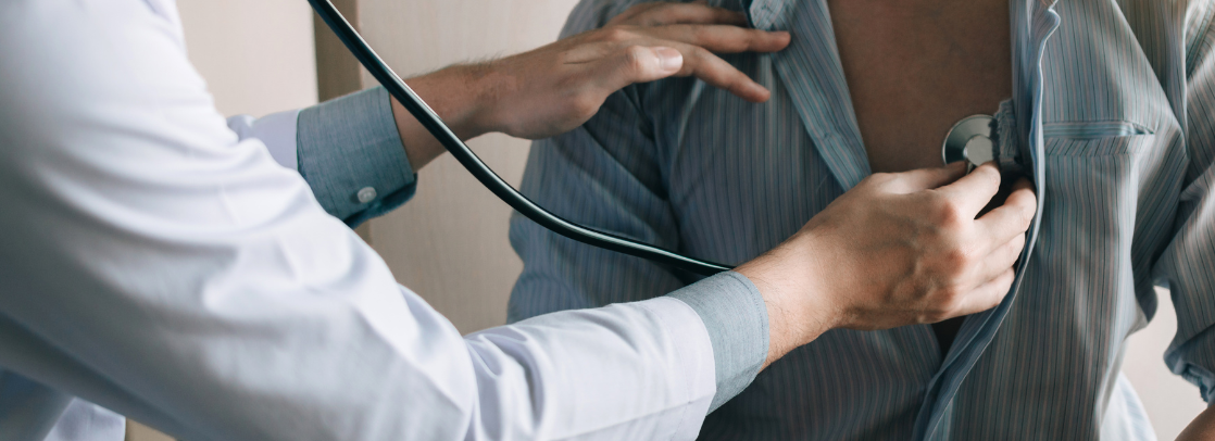 A physician listens to a patient's heart with a stethoscope A physician listens to a patient's heart with a stethoscope