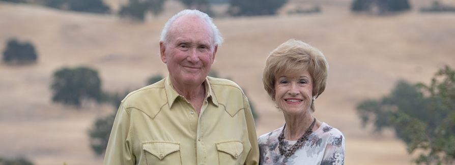 Stan and Barbara Clark outside smiling looking at camera.