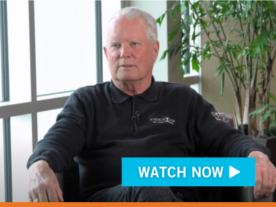 Video Still Image of John Summer. Watch Now Button overlaid.
