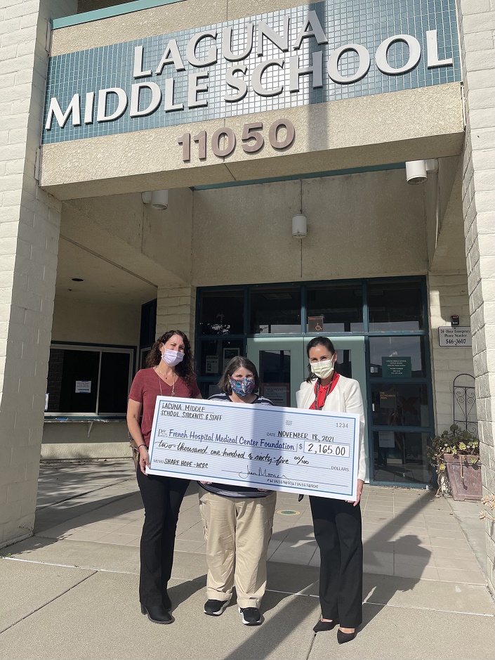 Two Laguna Middle School teachers present a check to Foundation staff.