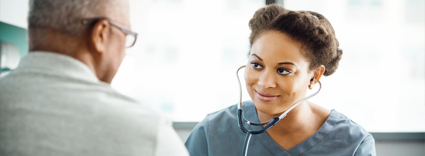 Image of a smiling nurse with a patient. Image of a smiling nurse with a patient.