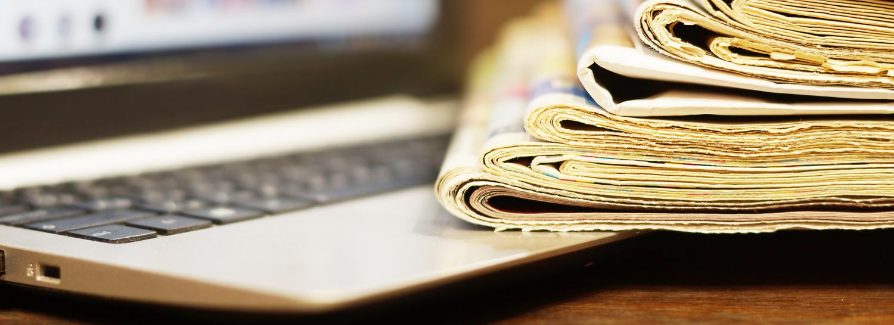 Newspapers folded on top of laptop keyboard Newspapers folded on top of laptop keyboard