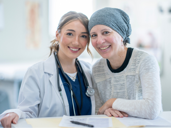 Portrait of a smiling a female physician and female cancer patient