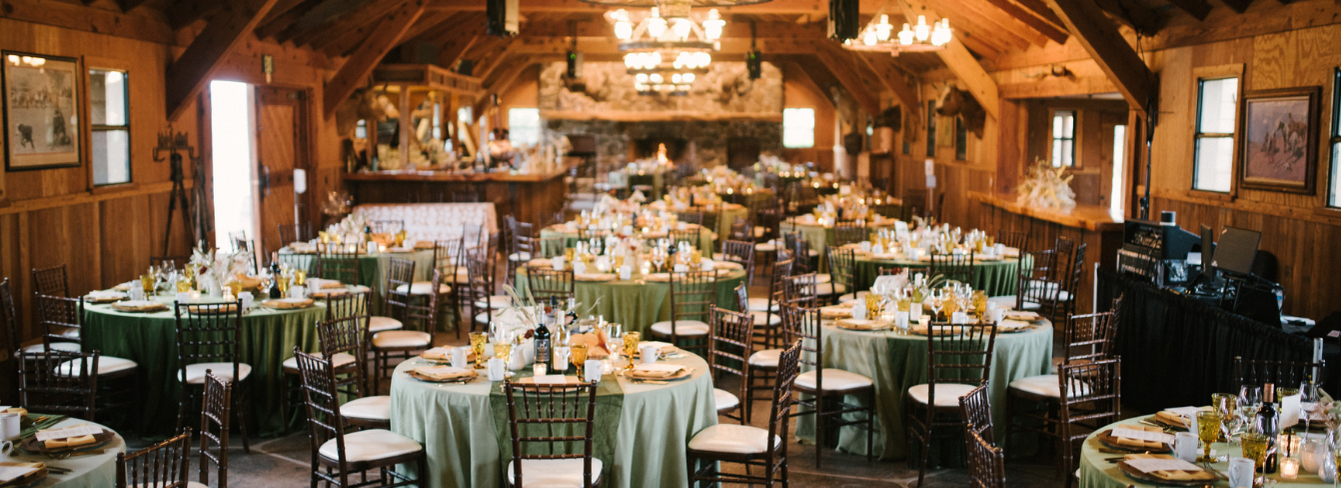 Tables set and decorated for the Share the Hope Event in the Hearst Ranch Dairy Barn.