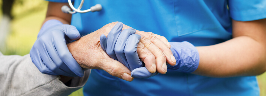 Caregiver holding patient hand