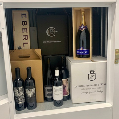 Wine Locker at Meathead Wine Storage sits with the door open displaying cases of wine inside 