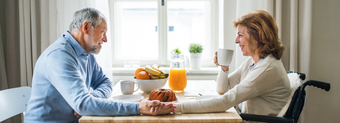 Couple holds hand at table