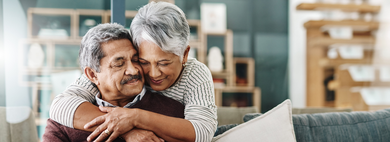 Couple smiles during hug